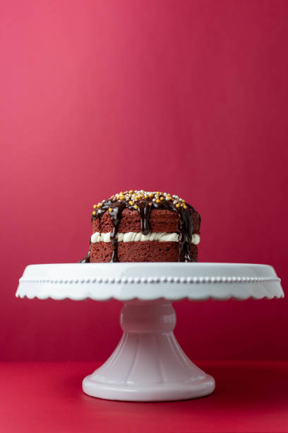 istock Red velvet cake on red background 1296396139