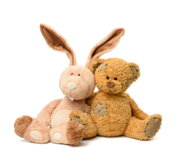 istock brown teddy bear and cute rabbit sit on white isolated background 1296401437