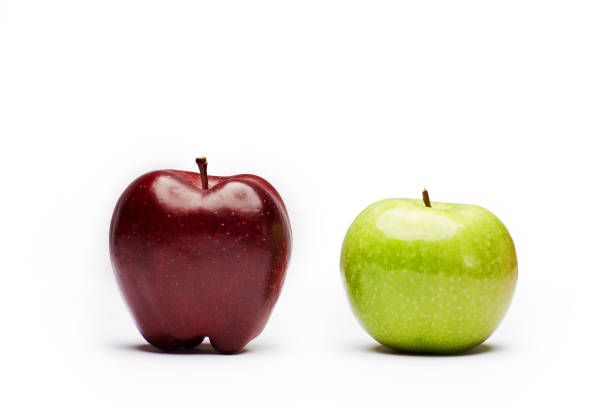 istock Two raw fresh clean red and green apples on the white background 1296401911
