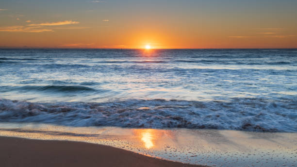 istock South Coast Sunrise Seascape and light high cloud 1296403449