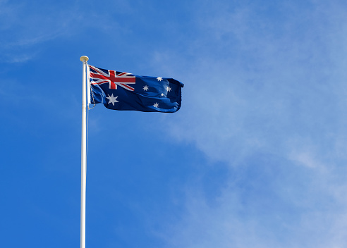 Australian flag on a white pole.