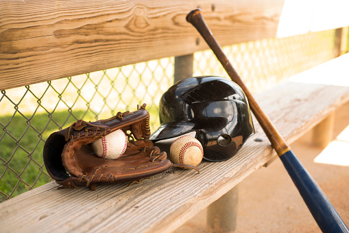 Spring and summer baseball season is here.  Baseball equipment in the dug out.  Great background images.