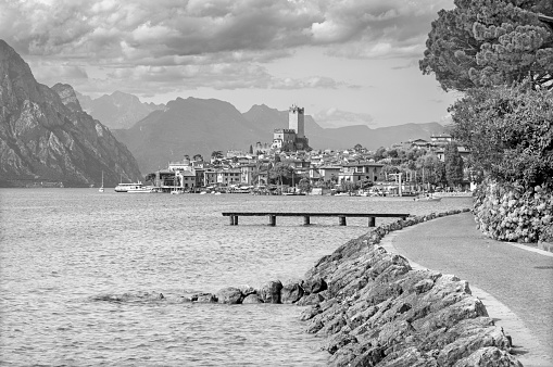 Malcesine - The promenade over the Lago di Garda lake with the town in the background.