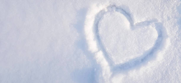 heart drawn on the snow in the park. Valentine's Day, winter vacation in the city stock photo