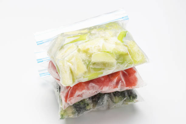 istock A stack of packages of frozen vegetables on white background close-up 1296410879