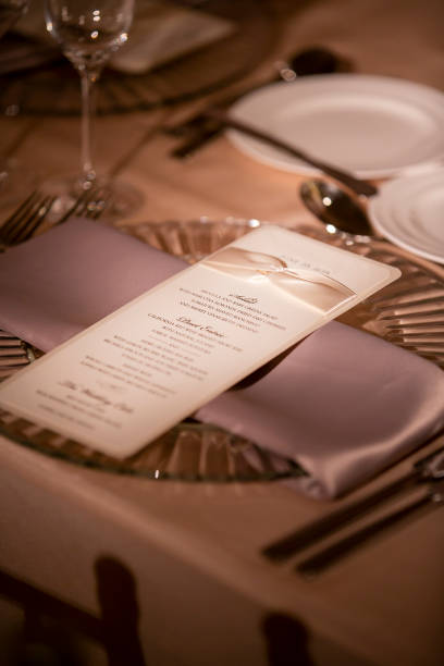 istock Place Setting and Menu For A Wedding Ceremony In A Dimly Lit Venue 1296413332