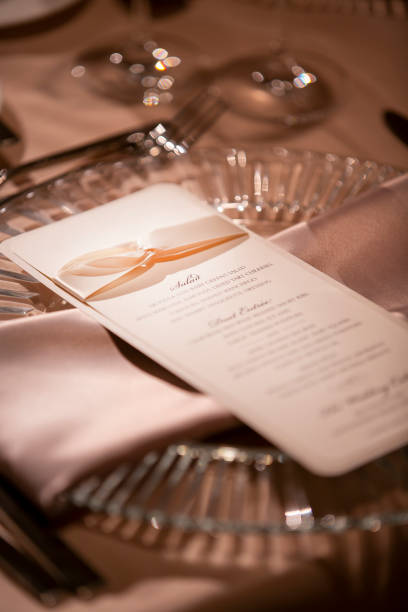 istock Place Setting and Menu For A Wedding Ceremony In A Dimly Lit Venue 1296413333