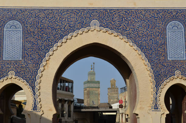 Minaret of Bou Inania Madrasa Seen Through Bab Bou Jeloud in Fes, Morocco Fes, Morocco - August 18, 2014: The minaret of the Bou Inania Madrasa in Fes el Bali, the old city of Fes, seen through the Bab Bou Jeloud city gate. bab boujeloud stock pictures, royalty-free photos & images