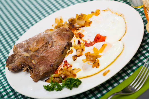 istock Image of dish of tasty cooked fried pork with  fried eggs 1296415793