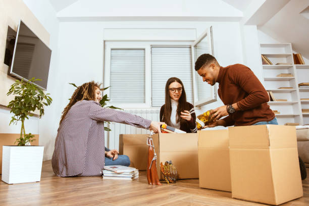istock Young adults pack things in cardboard boxes and get ready to moving 1296419470