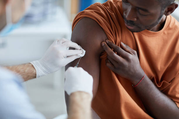 istock African Man Vaccinating against Covid Close Up 1296420390