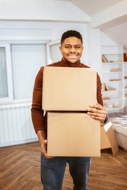 istock Young adults with cardboard boxes are get ready to moving 1296420437