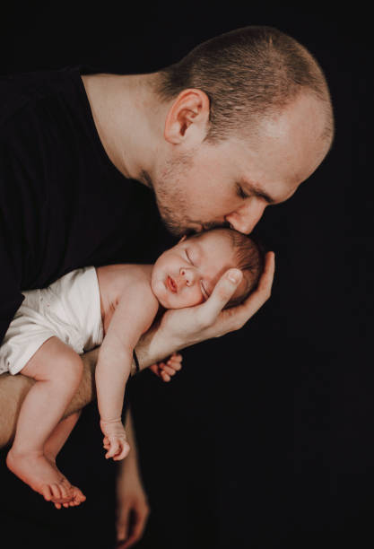 istock Father holding his newborn baby 1296422371