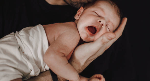 istock Father holding his newborn baby 1296422938