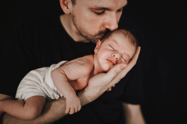 istock Father holding newborn baby 1296422999
