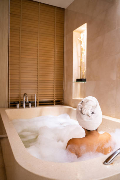 istock women soak in warm water bathtub 1296423997