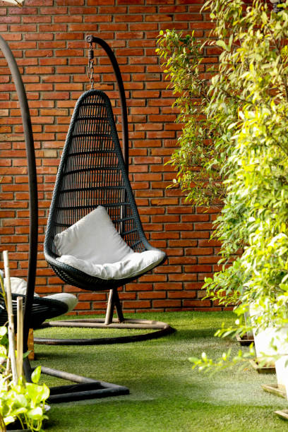 istock hanging chairs in a garden on sunny summer day. 1296426602