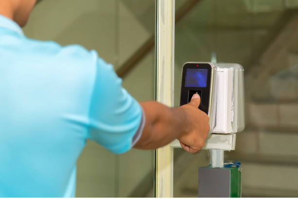 istock The hand are scanning on fingerprint machine for enter digital security door system in the office building at Bangkok ,Thailand.  Fingerscan with access control on the glass door. 1296427240