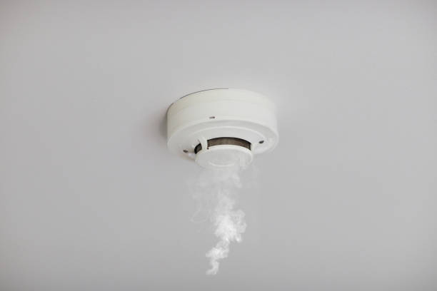 Smoke detector on white ceiling Smoke detector on white ceiling. Close up of smoke detector for fire protection systems. Selective focus. fire inspection stock pictures, royalty-free photos & images