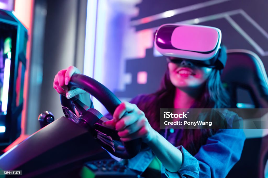 woman play 3D vr game asian woman wears vr glasses and play car racing online video games Virtual Reality Simulator Stock Photo