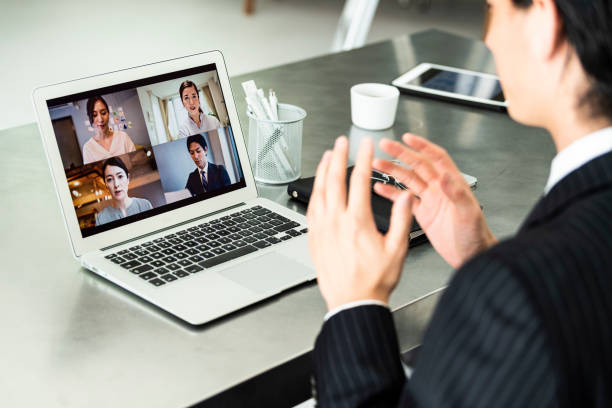 A businessman wearing suits are doing online meeting at an office A businessman wearing suits are doing online meeting at an office remote location stock pictures, royalty-free photos & images
