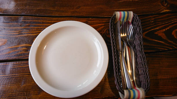 istock Empty White Plate and cutlery are on the table 1296436622