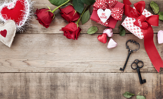 Valentine's Day Roses and Chocolates on a Wood Background. Directly above.