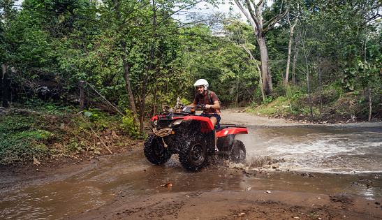 Hispanic teenager driving an off-road vehicle Costa Rica