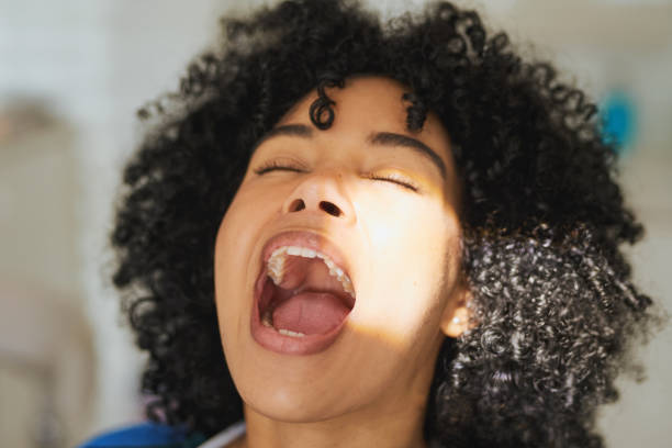 Open up and say aaahhh Shot of a young woman opening her mouth in preparation of a dental procedure mouth open stock pictures, royalty-free photos & images