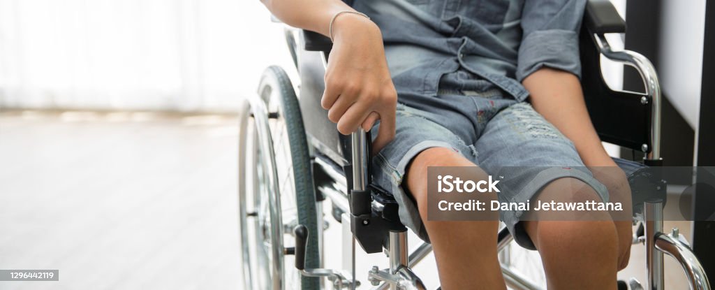 Disability polio patient sitting on wheelchair in hospital, Banner with copy space Polio Stock Photo