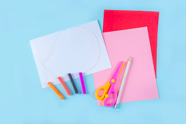 istock DIY and kid's creativity. Step by step instruction: how to make valentine card, hedgehog with hearts. Step1 preparation tools (sheets of colored paper, pencils, scissors). Craft for Valentines day. 1296444461