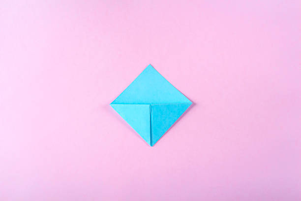 DIY and kid's creativity, origami. Step by step instruction: how to make bookmark easter bunny. Step 7 Bend left corner up, and turning down its upper part inward. Easter craft