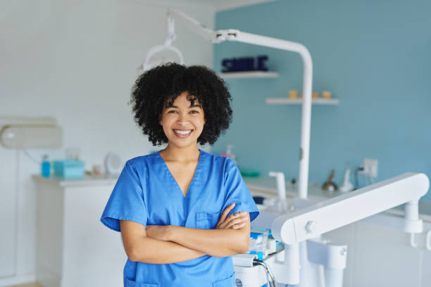 Let's get these teeth looking good again Portrait of a confident young woman working in a dentist’s office medical scrubs stock pictures, royalty-free photos & images