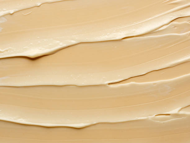 istock texture of nude cream on beige background. 1296446516