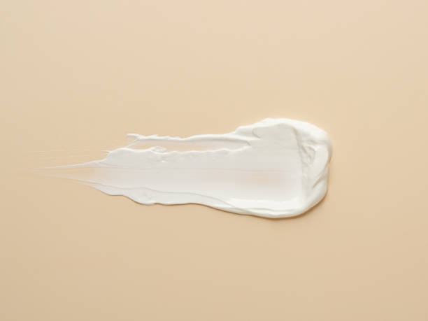 istock texture of white cream on beige background 1296446612