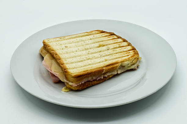 istock Toast bread sandwich ham with melted tilsiter cheese on white dish, isolated on white background 1296447745
