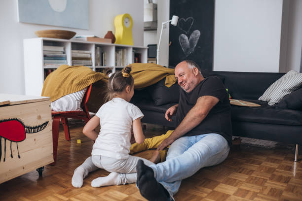 istock father playing with his kids at home 1296448314