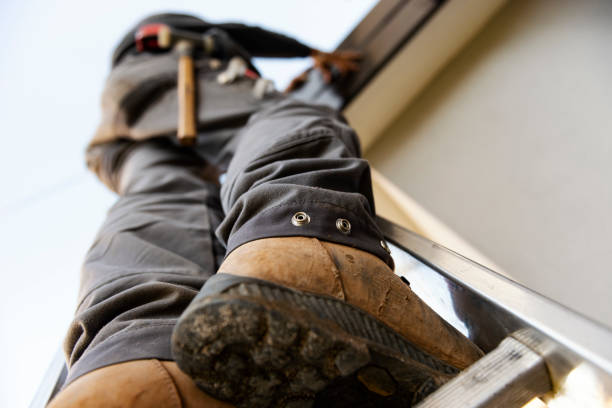 istock Worker on roof installing metal tile 1296448377
