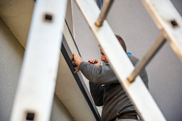 istock Manual worker on roof installing metal tile 1296448388