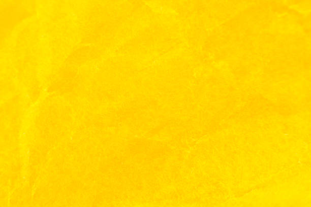 istock Crumpled yellow paper background. Real macro battered texture. Close up photo. 1296448688