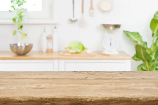 Photo of Wood table top on blur kitchen room counter background