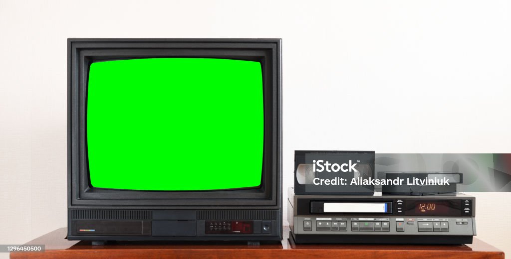 Old black vintage TV with green screen to add new images to the screen, VCR on wallpaper background. Television Set Stock Photo