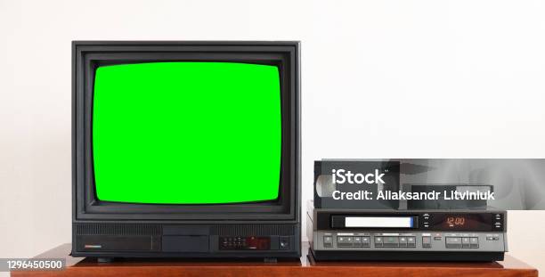 Old Black Vintage Tv With Green Screen To Add New Images To The Screen Vcr On Wallpaper Background Stock Photo - Download Image Now