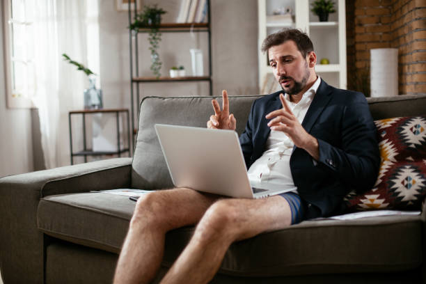 istock Businessman working online, wearing suit and no pants. 1296450572