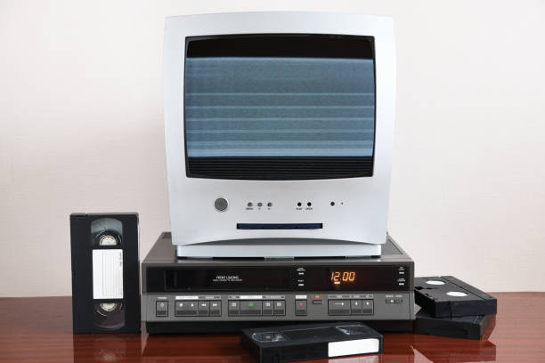 istock Old silver TV with noise and interference on screen with built-in DVD player and vintage video recorder from 1980s, 1990s, 2000s. 1296450604