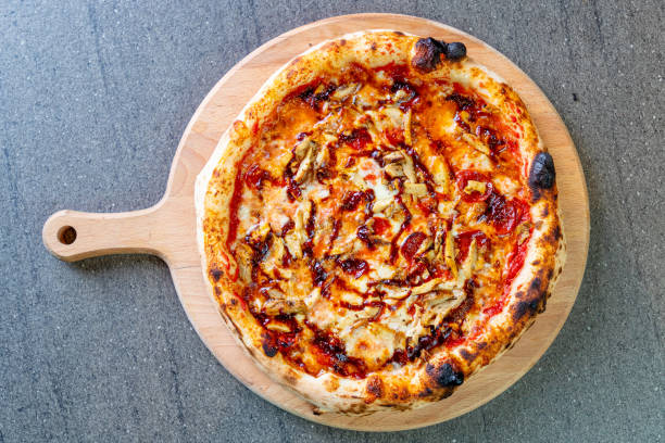 istock Directly above pizza with melting cheese, chicken meat chops and cherry tomato 1296451258