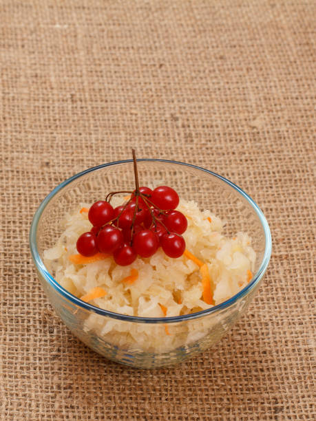istock Fermented cabbage with herbs and spices in glass bowl on sackcloth. 1296455369
