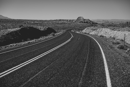 The great winding open road of the SW desert of the United States. Black and white landscapes found in SW Utah.