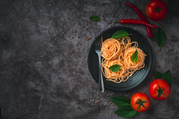 Spaghetti with tomato sauce and minced meat, Parmesan cheese and basil Black background. Top view copy space