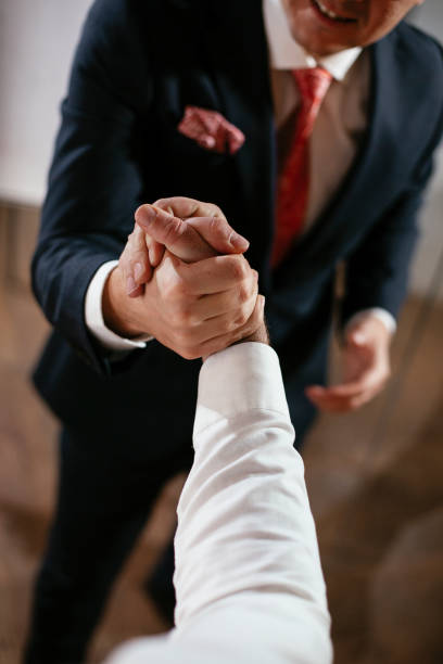 istock Close up of men handshake in office. 1296459216